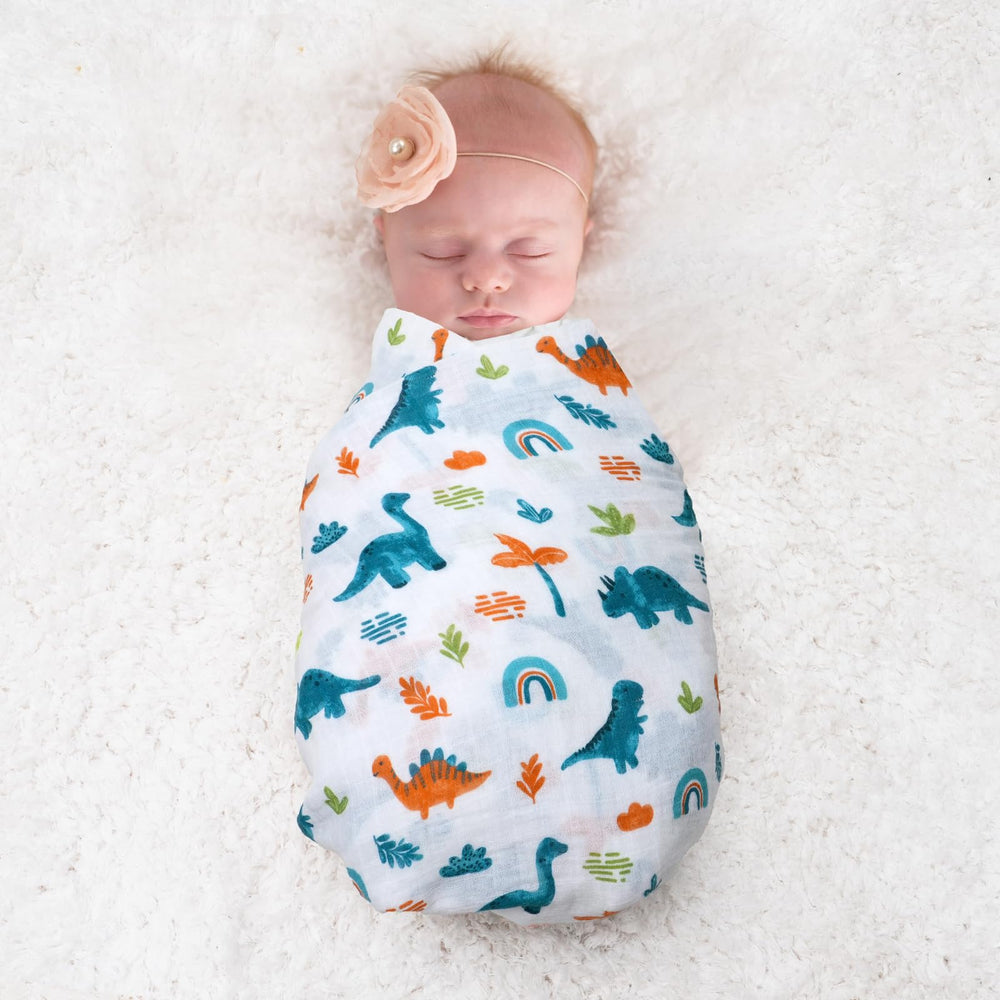 David's Kids dinosaur blue swaddle blanket in pram demonstrates multipurpose daily use.