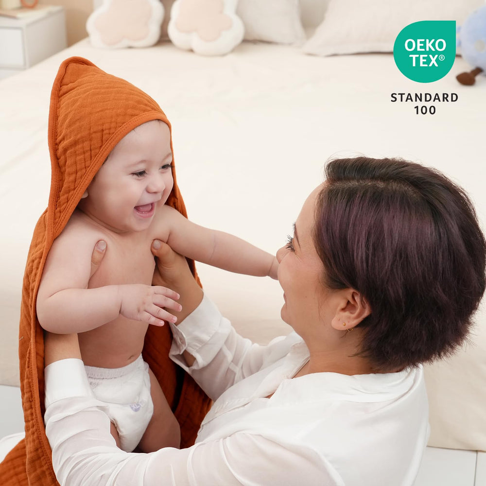 David's Kids hooded baby towel brown 32x32 on baby shows fast absorbency after bath.