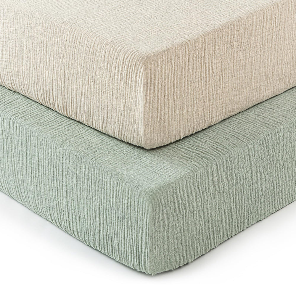 David's Kids muslin crib sheets in oat-milk folded, ultra-soft and breathable.