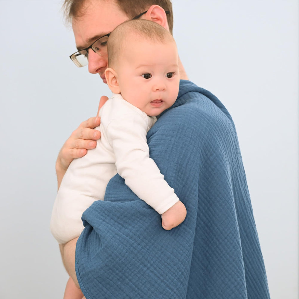 David's Kids Prussian Blue muslin blanket on stroller for shade and cover.