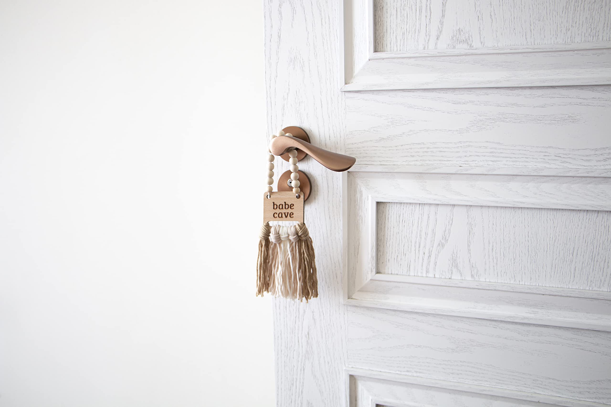 Decocove Babe Cave Sign tassels closeup shows tactile baby-friendly decor.