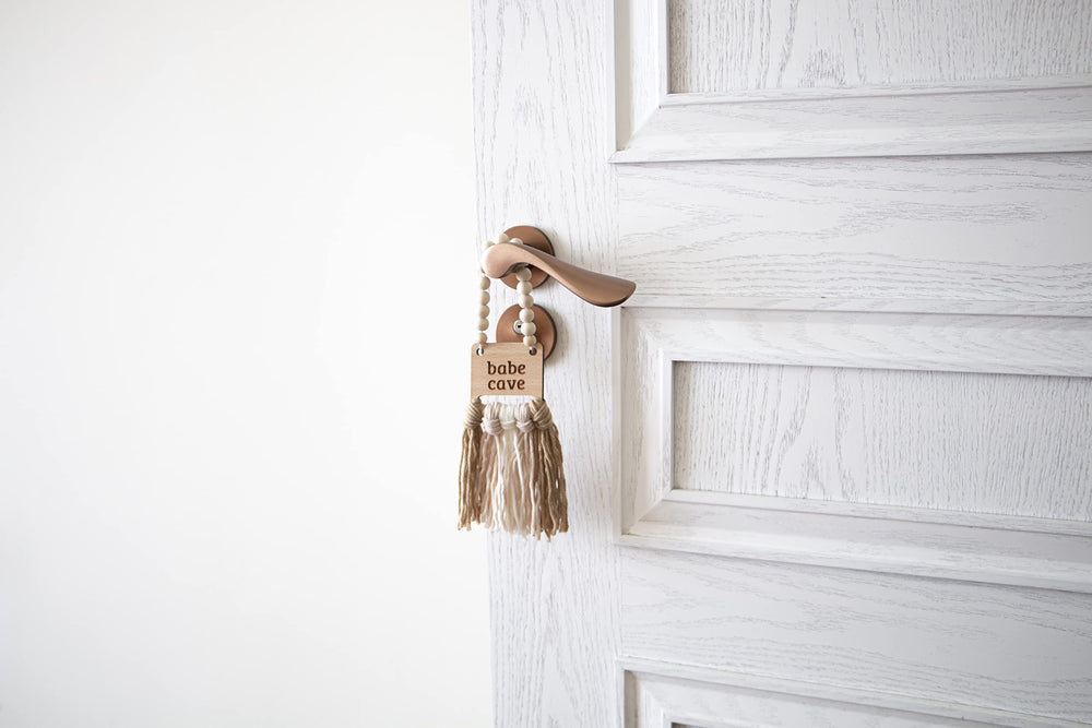Decocove Babe Cave Sign tassels closeup shows tactile baby-friendly decor.