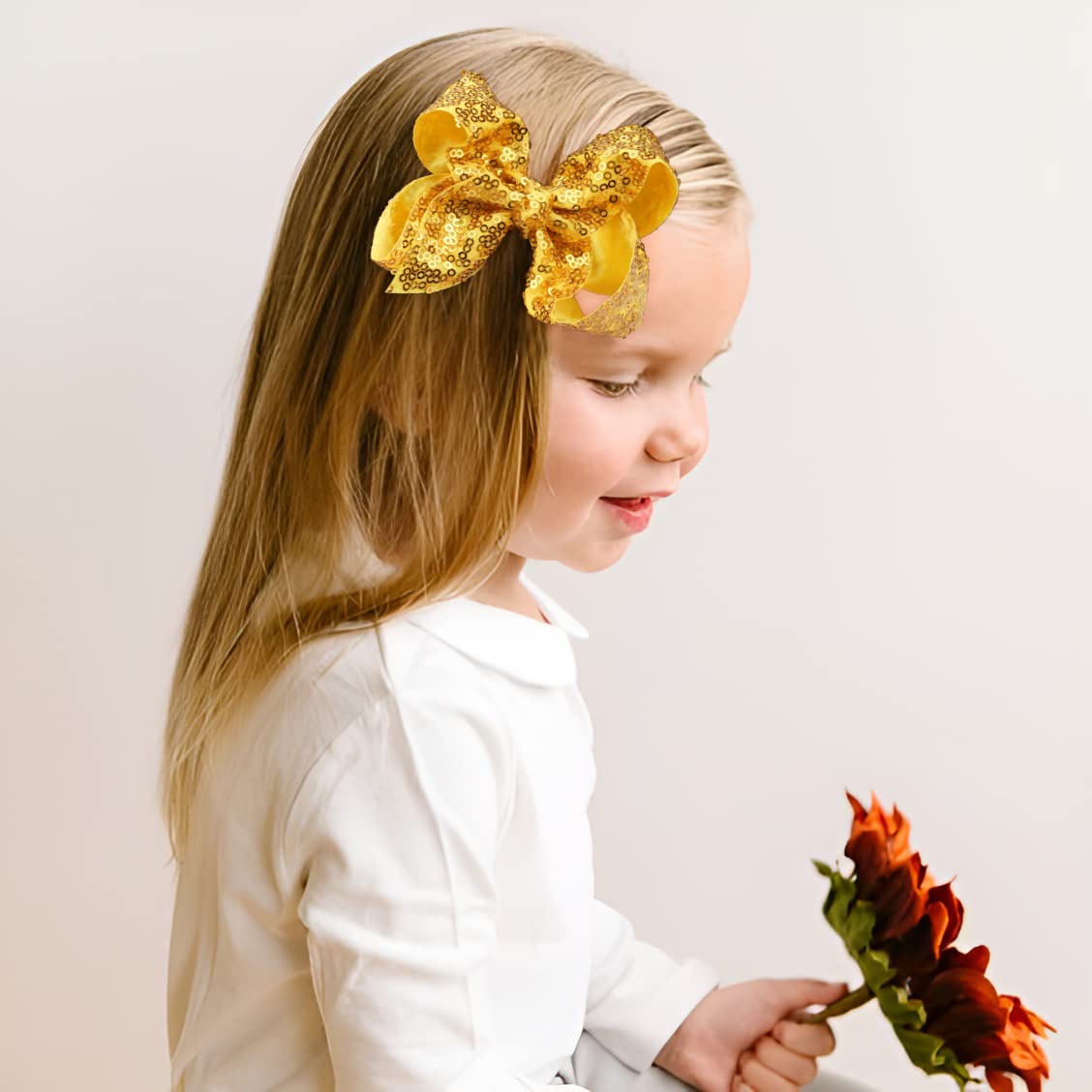 DED in-use hair bow clip securing style with sparkle.