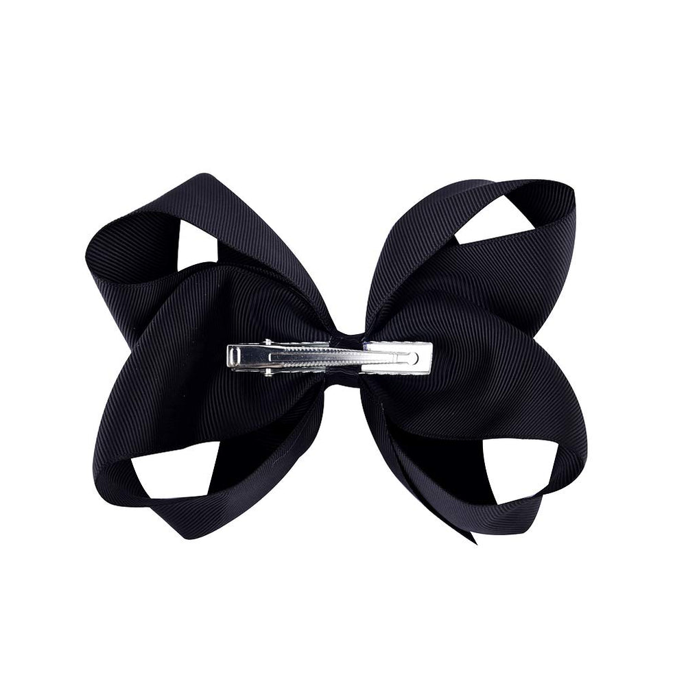 DEEKA closeup of the alligator-clip bow shows sturdy attachment and soft texture.