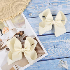 DEEKA ivory bow on a ponytail showing quick styling for mornings.