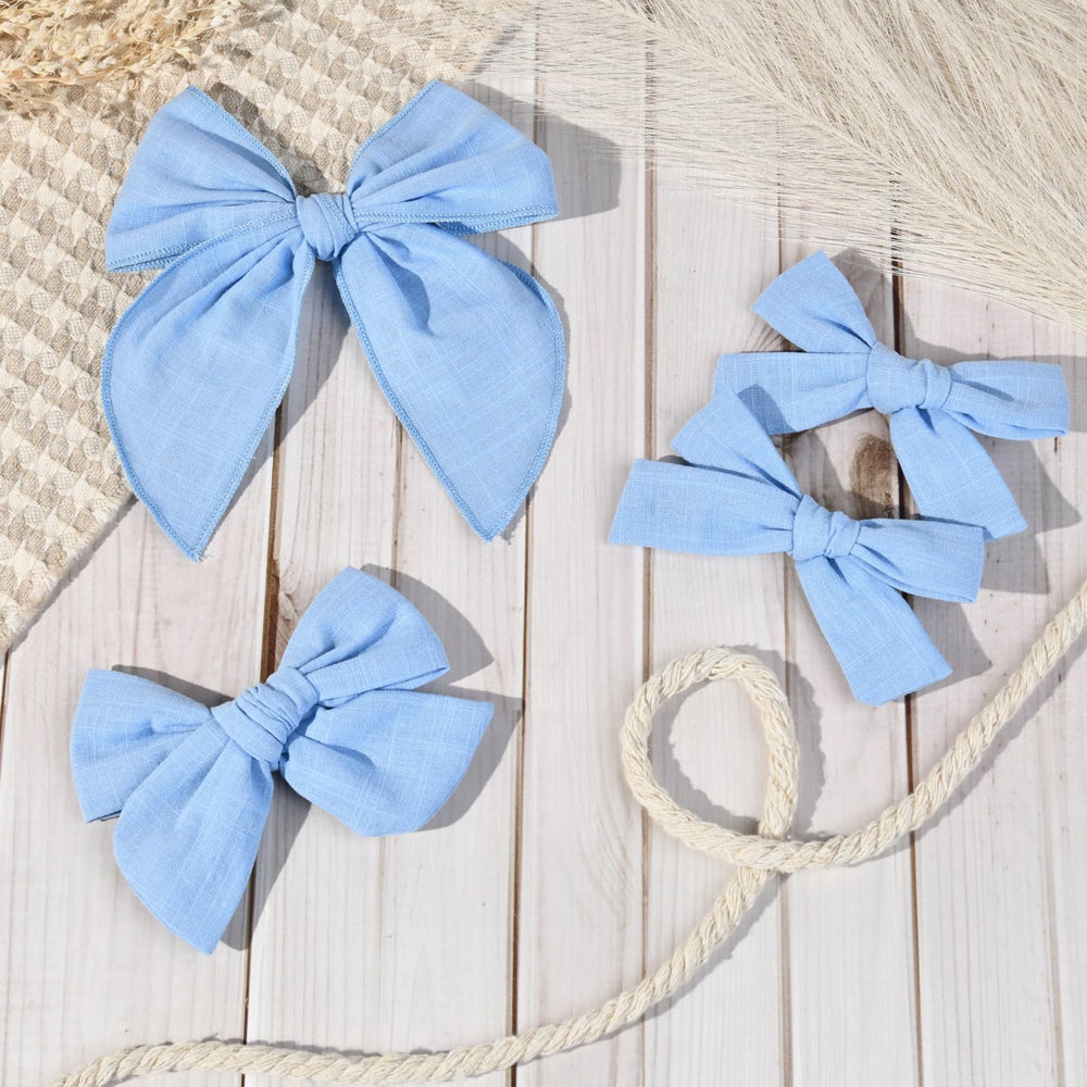 DEEKA blue bow set packaging highlights four-piece collection for versatile styling