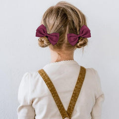 DEEKA burgundy elastic-band bows demonstrate quick-styling versatility for busy mornings