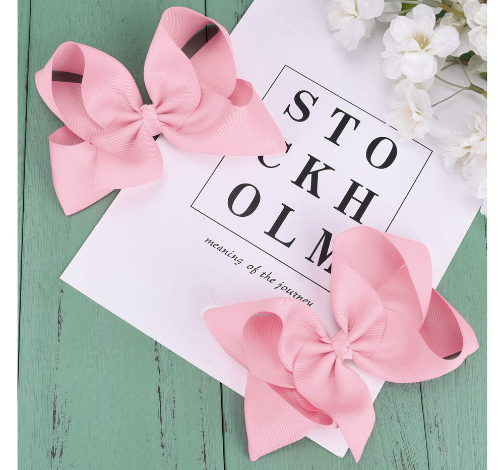 DEEKA light pink bow styled in a bun for versatile back-to-school looks.