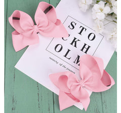 DEEKA light pink bow styled in a bun for versatile back-to-school looks.