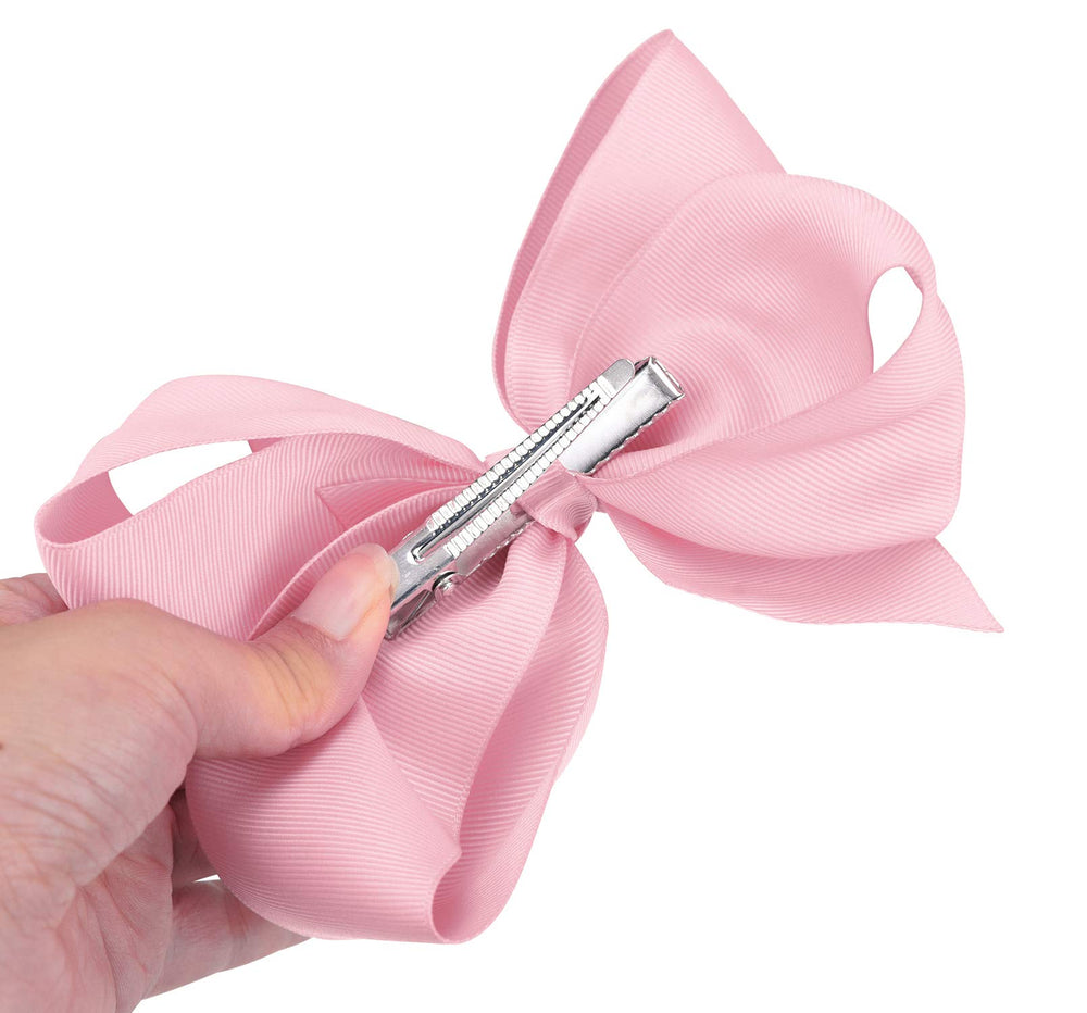 DEEKA light pink bow worn in a ponytail for secure, comfortable all-day wear.