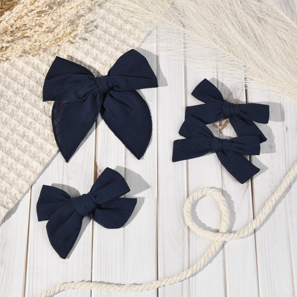 DEEKA navy blue bow styled for a side ponytail, polished school-ready look