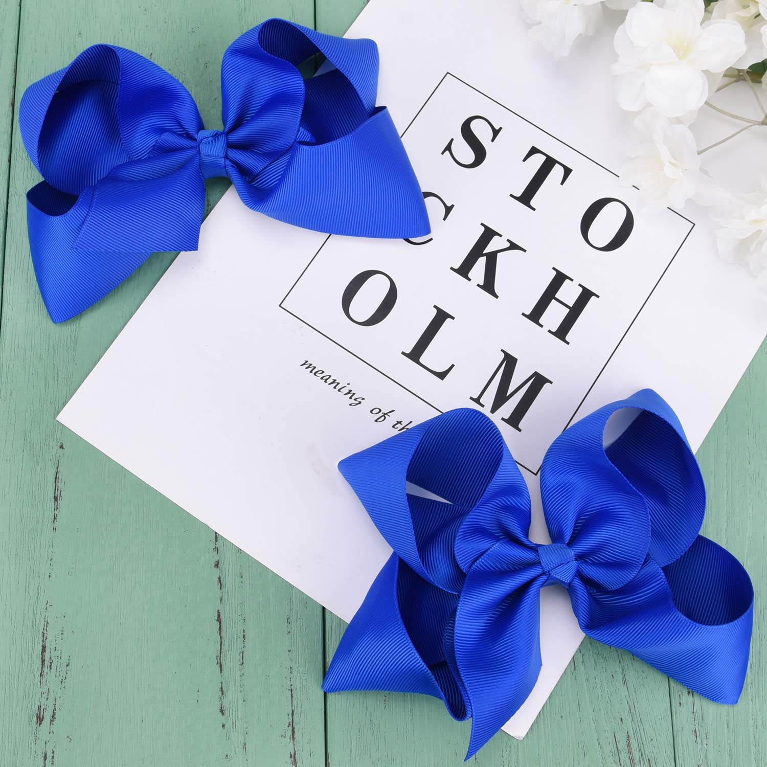 DEEKA royal blue bow paired with a dress adds festive color and polish