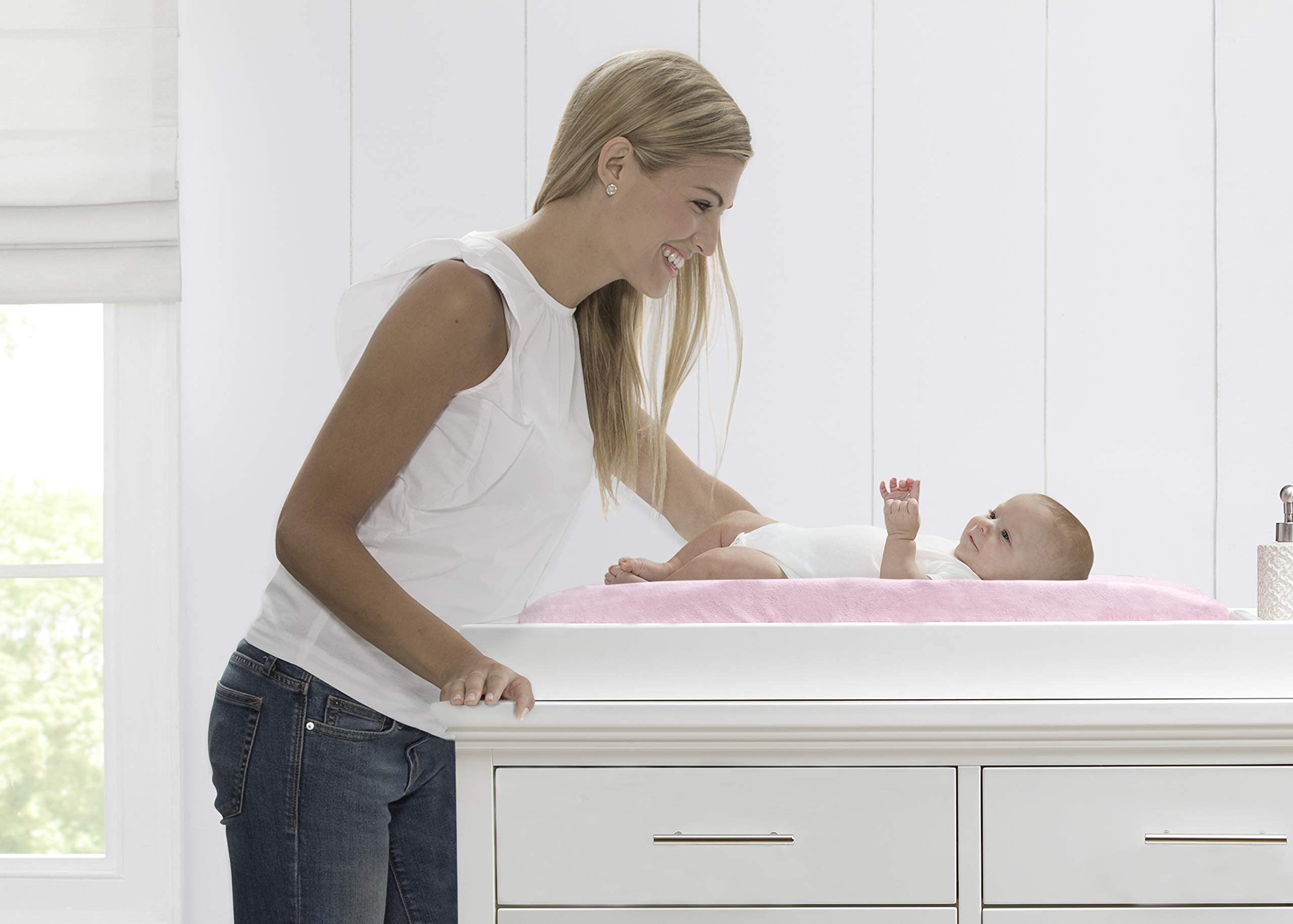 Delta Children contoured pad includes safety strap with quick release buckle for security.