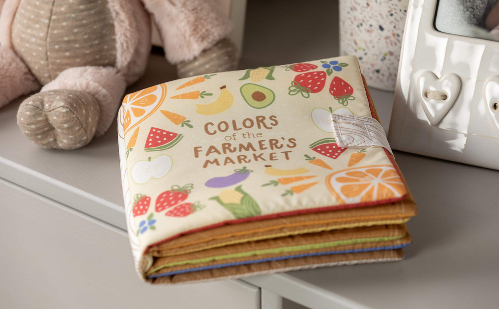 DEMDACO Farmers Market Bright Colors fabric texture highlights soft touch for soothing baby interaction.