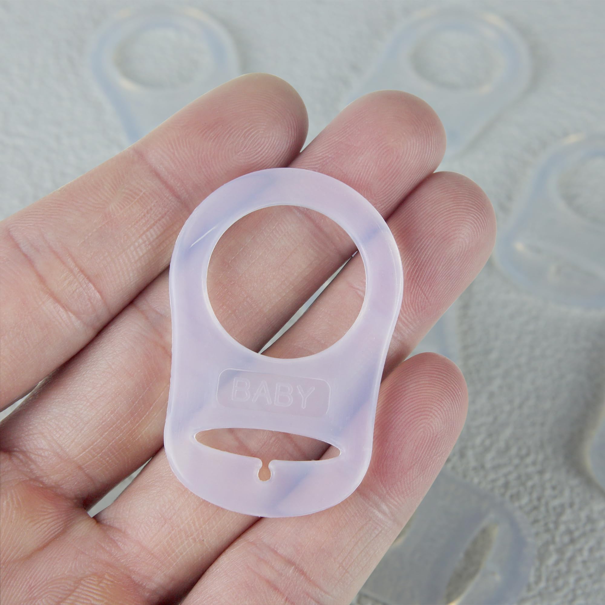 Demearly clear rings blend with pacifier colors for discreet use.