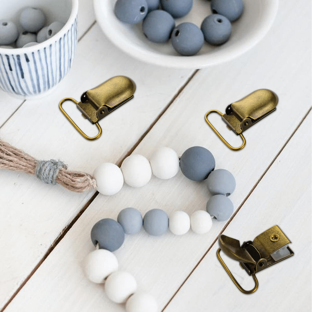 Demearly pacifier clip in use with bibs and toys for everyday organization