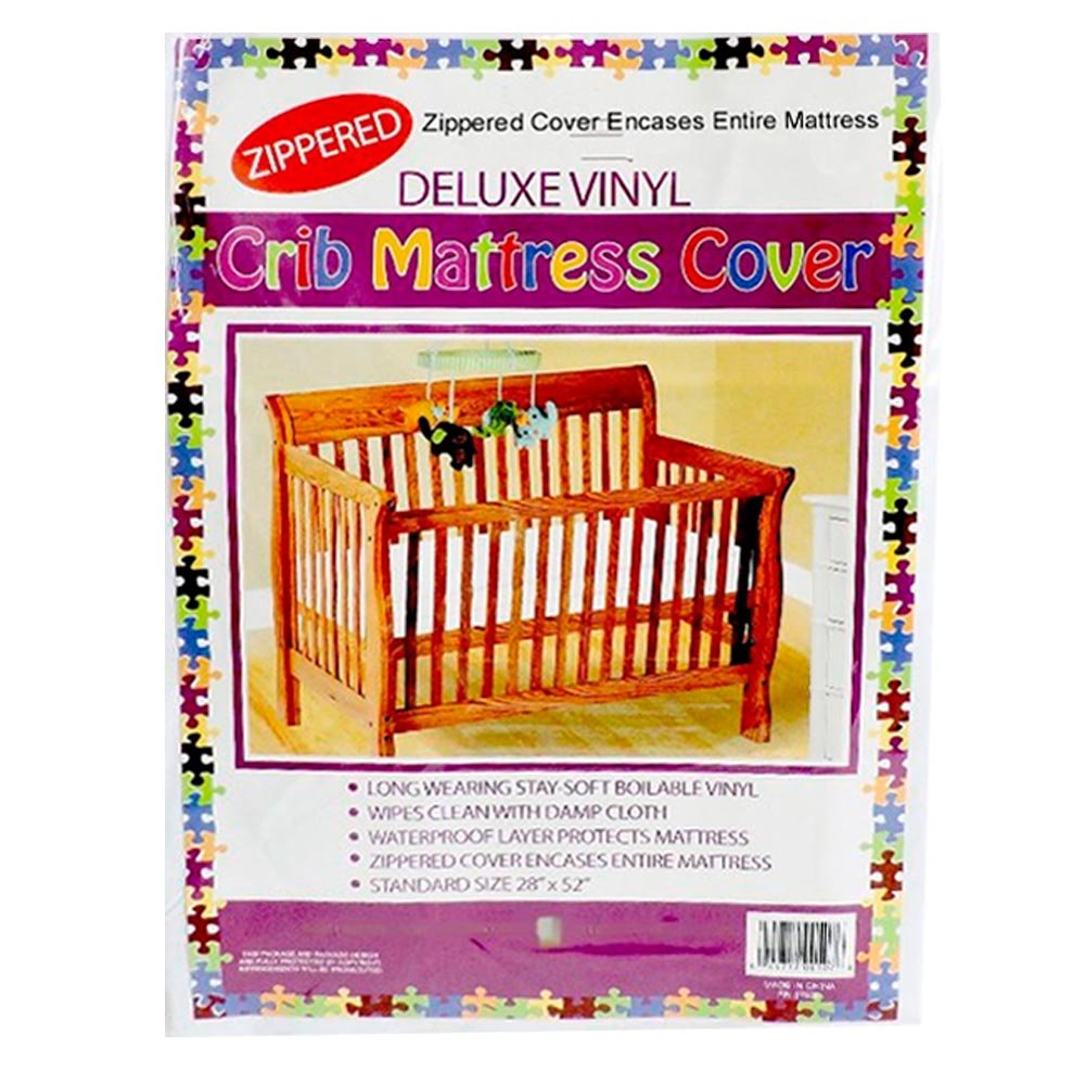 Dependable Essentials Deluxe crib mattress cover being wiped with a damp cloth for quick cleaning.