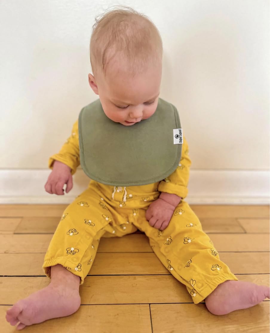 Diaper Squad drool bibs in earthy traditional palette complement outfits.
