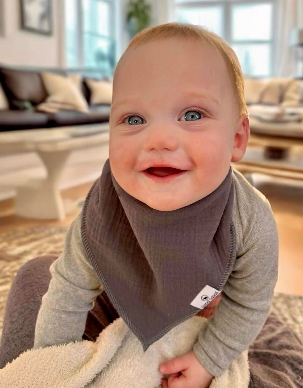 Diaper Squad bibs worn by baby; soft absorbent fabric keeps outfits dry.