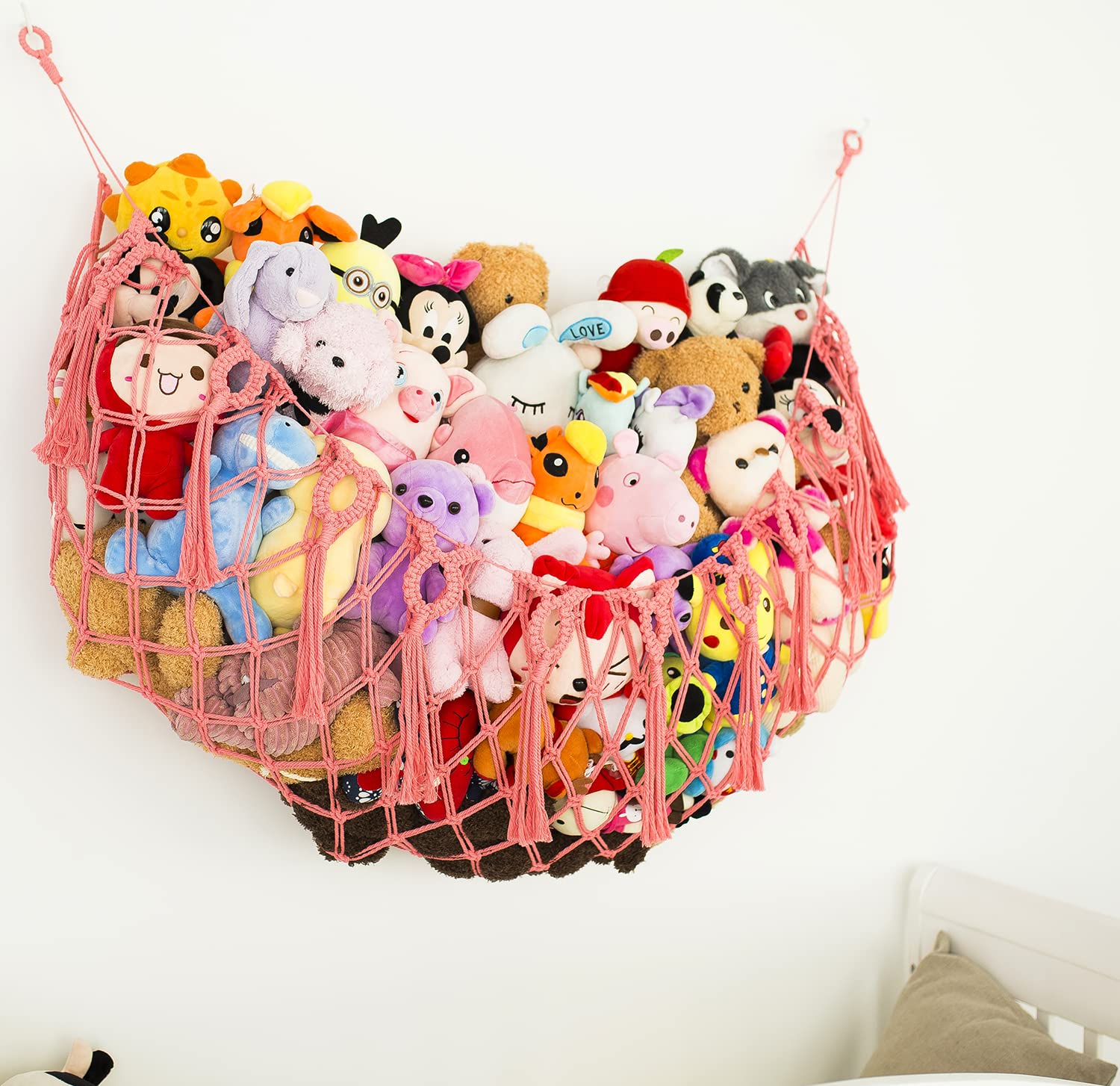 Diocos boho nursery hanging storage enhances decor while keeping toys tidy.
