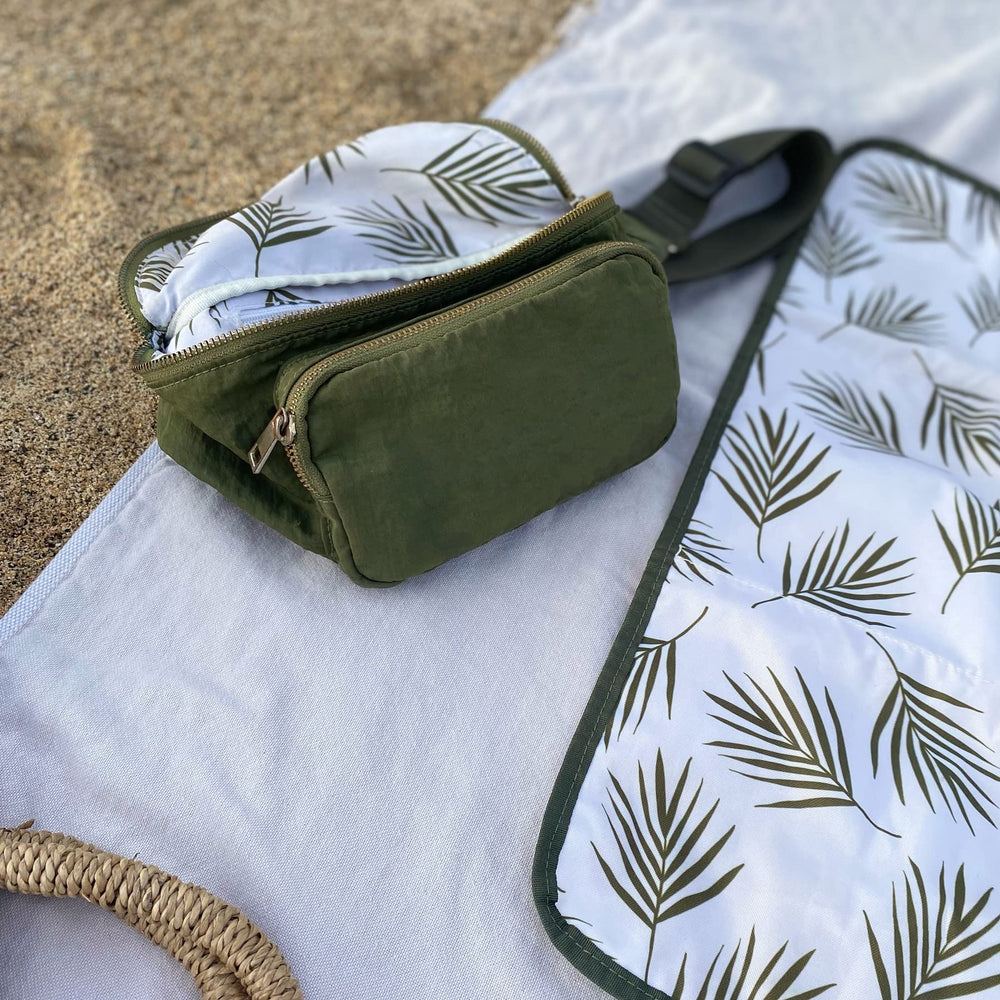 Ditty Co Lanikai changing pad with signature print folded into bag.