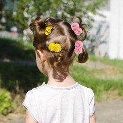 dizila pompoms hair ties on child demonstrate cute everyday hairstyle