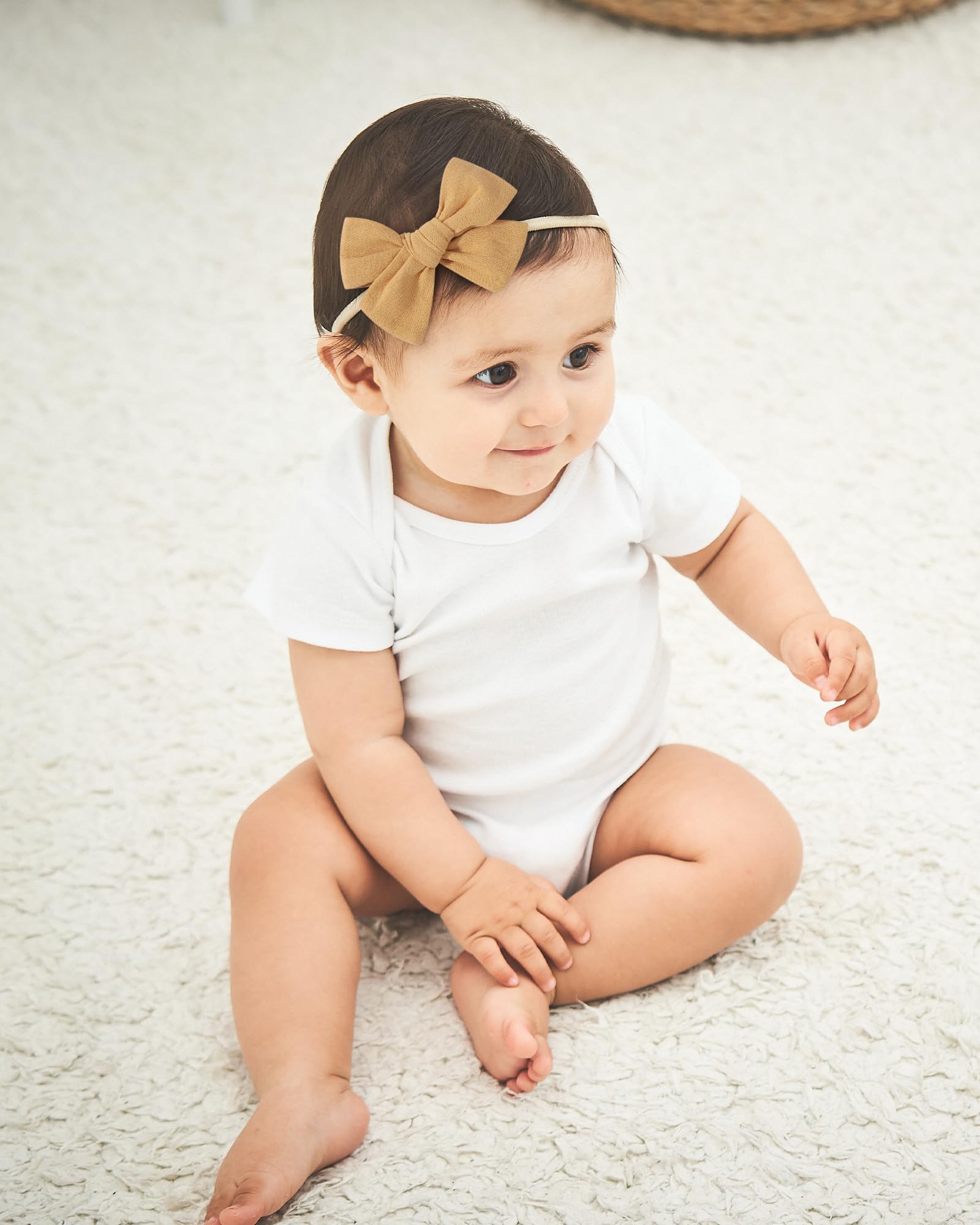 Doboi headbands styled on a smiling baby portrait for easy outfit coordination.