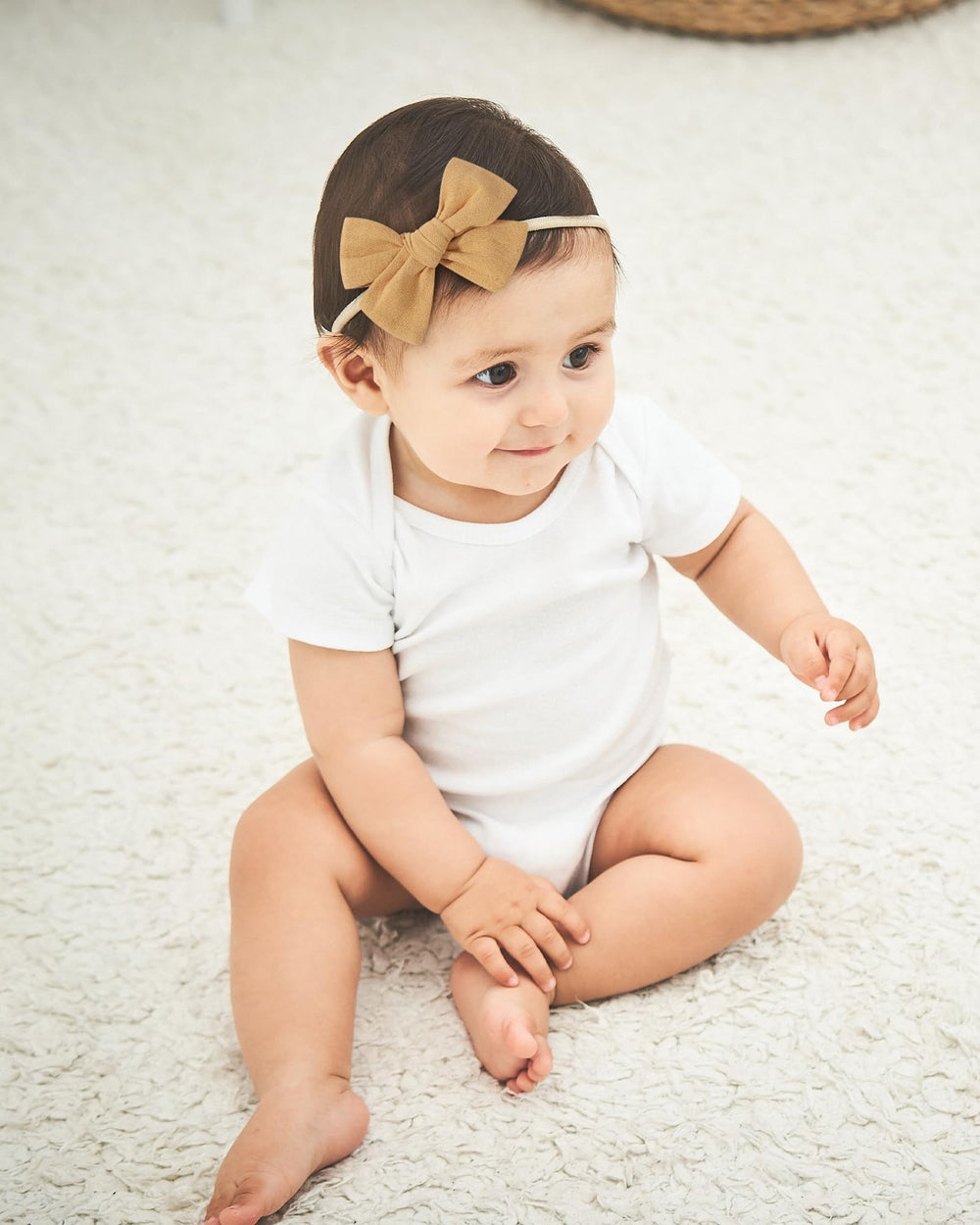 Doboi headbands styled on a smiling baby portrait for easy outfit coordination.