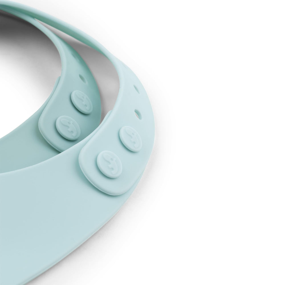 Done by Deer Elphee blue silicone bib with adjustable neck strap for secure fit.