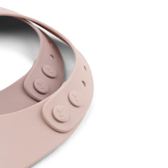 Close-up of Done by Deer Ozzo powder silicone bib's adjustable neck and double-button closures.