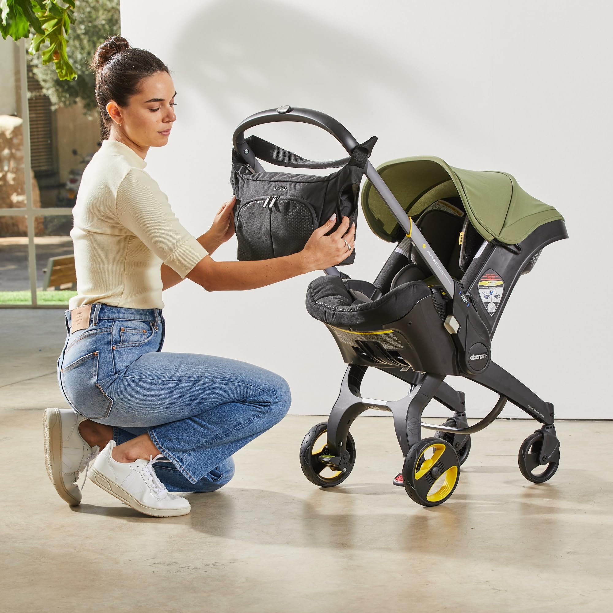 DOONA Essentials Bag Nitro Black includes changing mat for on-the-go diaper changes.