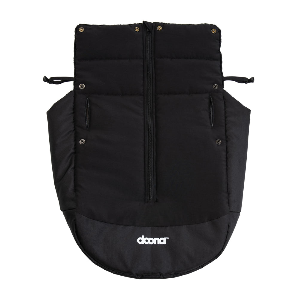 Doona Winter Cover over car seat shows wind protection and warmth.