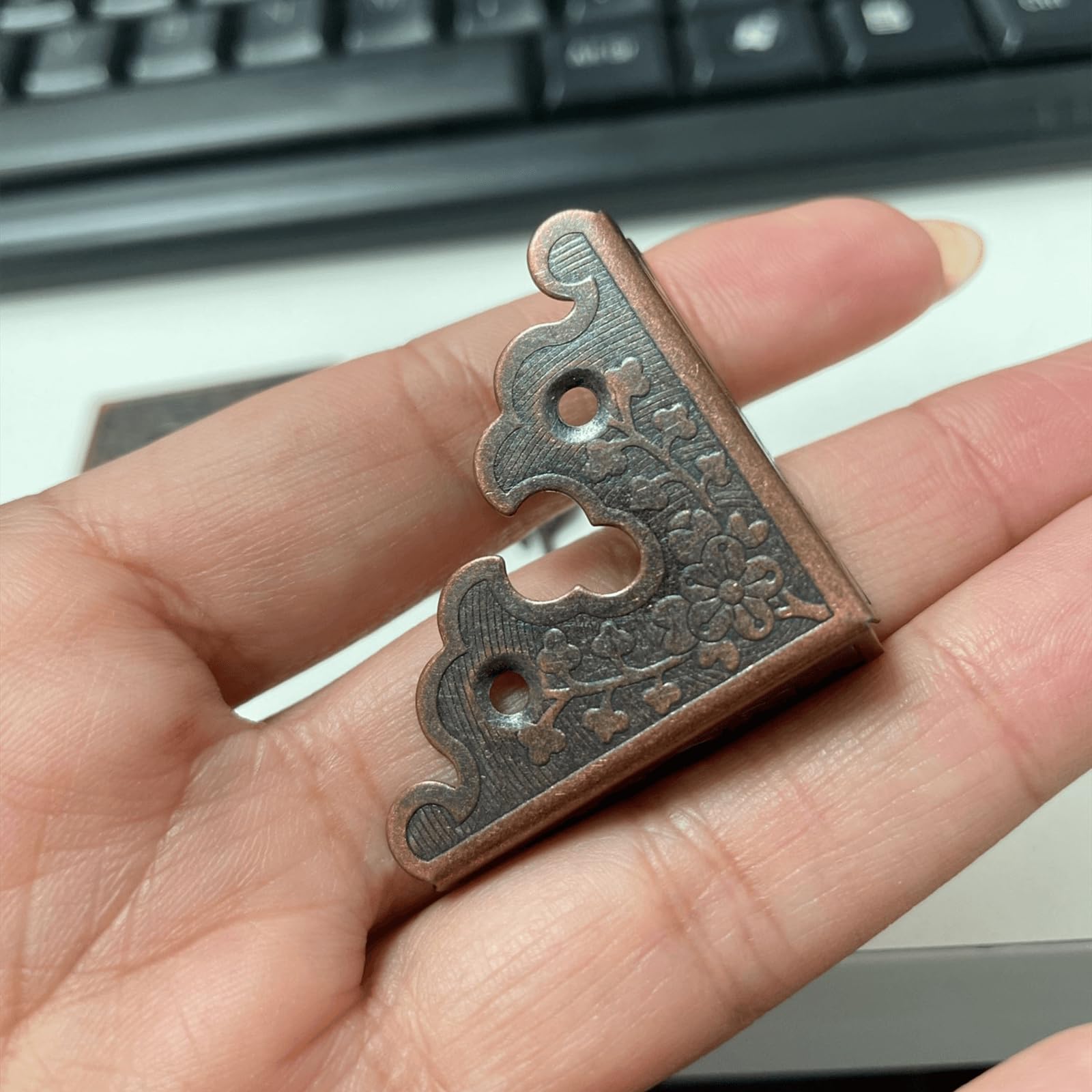 Dophee red copper corner guards protecting desk and table edges.