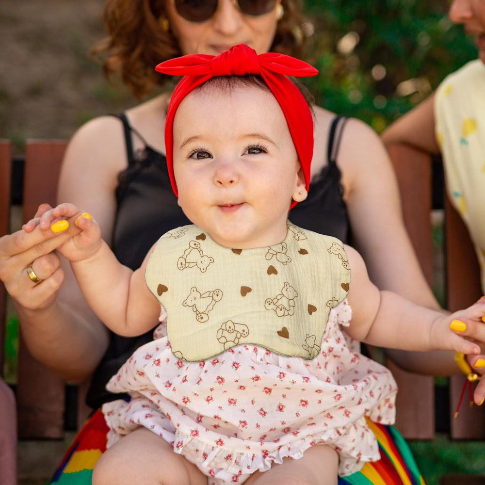 DOSMINE Muslin Baby Bibs with neutral patterns on a baby outfit