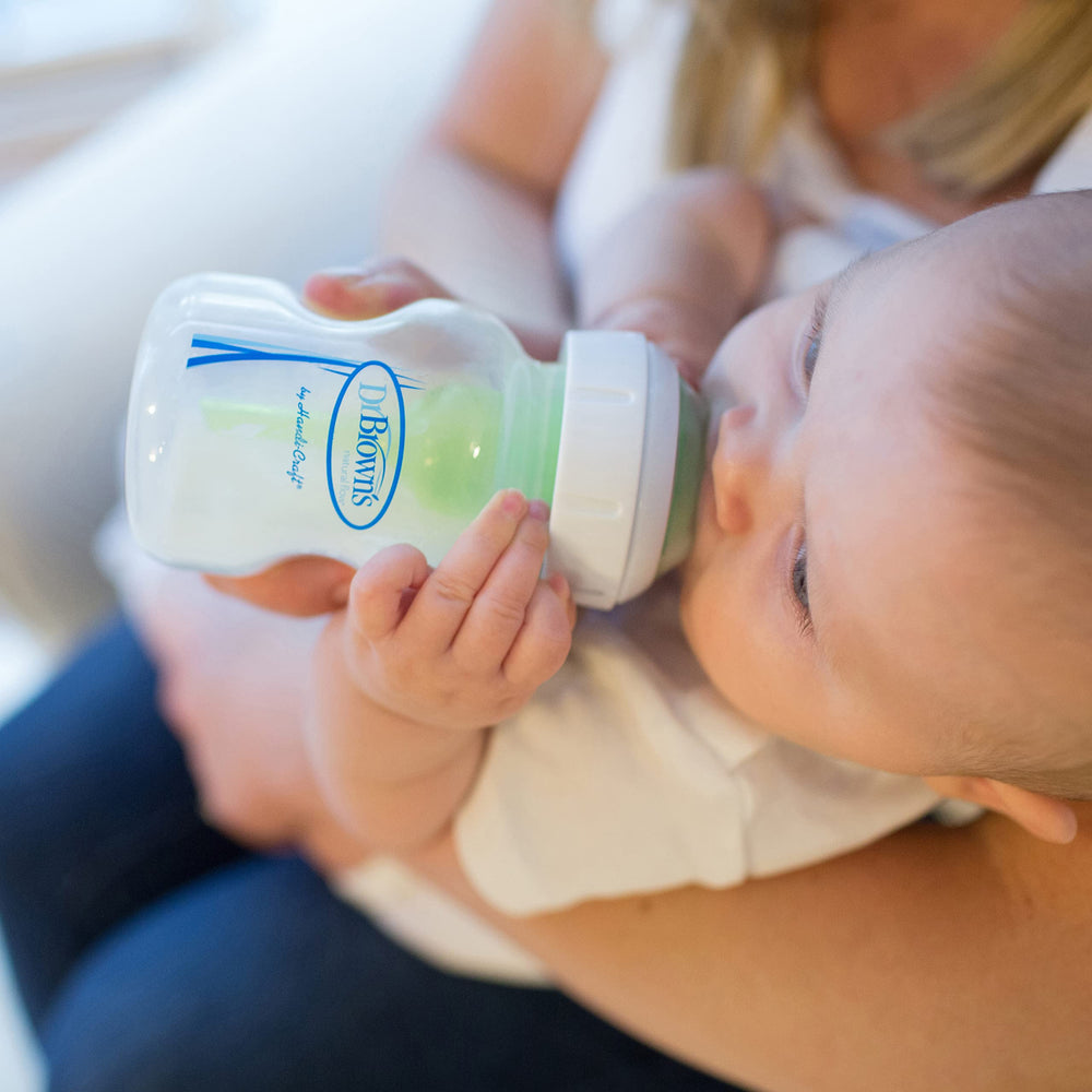 Dr. Brown's anti-colic vent night feed setup shows a calm feeding session