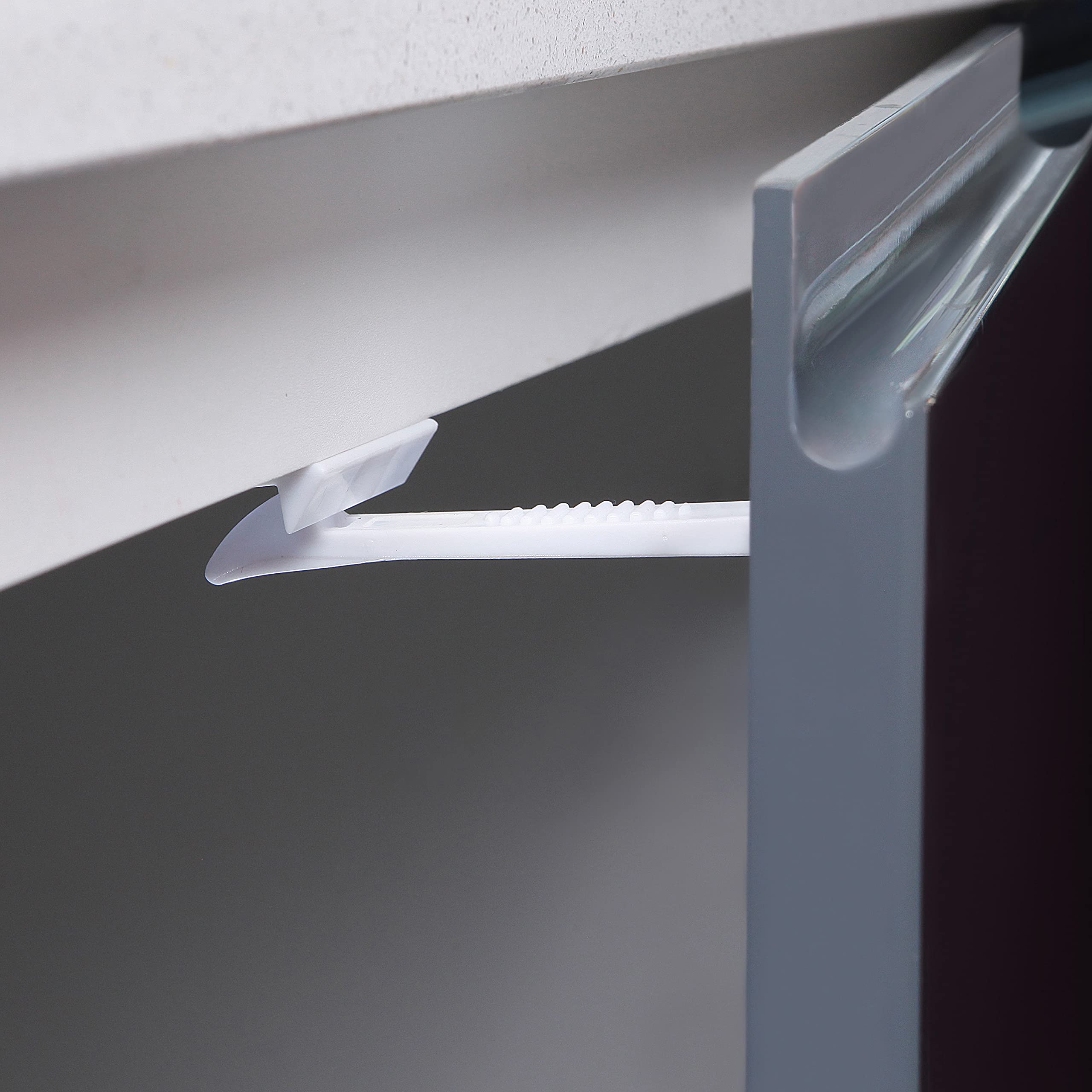 Dreambaby latch in use seals cabinet doors for safer kitchen activities