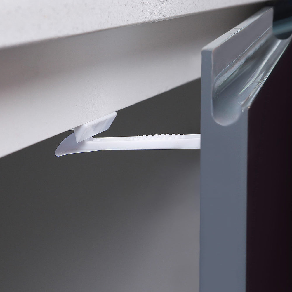 Dreambaby latch in use seals cabinet doors for safer kitchen activities