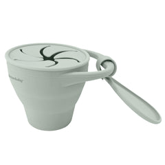 Dreambaby silicone toddler snack cup folded for ultra-compact storage in bags.