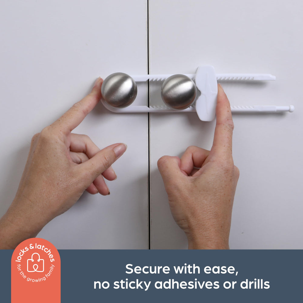 Dreambaby sliding locks securing kitchen cabinets, ideal for cluttered spaces