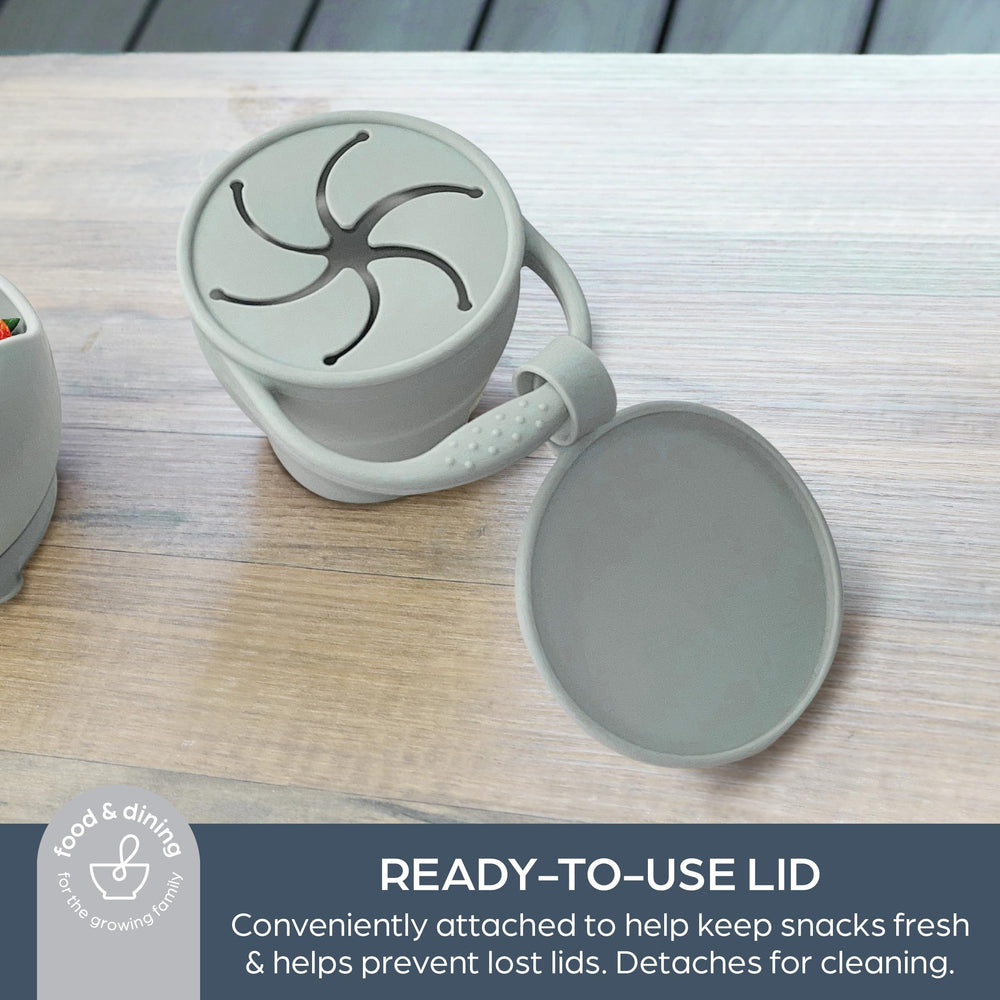 Dreambaby snack cup with integrated handle for easy toddler portability.