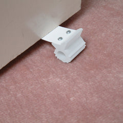 Dreambaby under-door gripper floor grip demonstrates reliable floor contact.