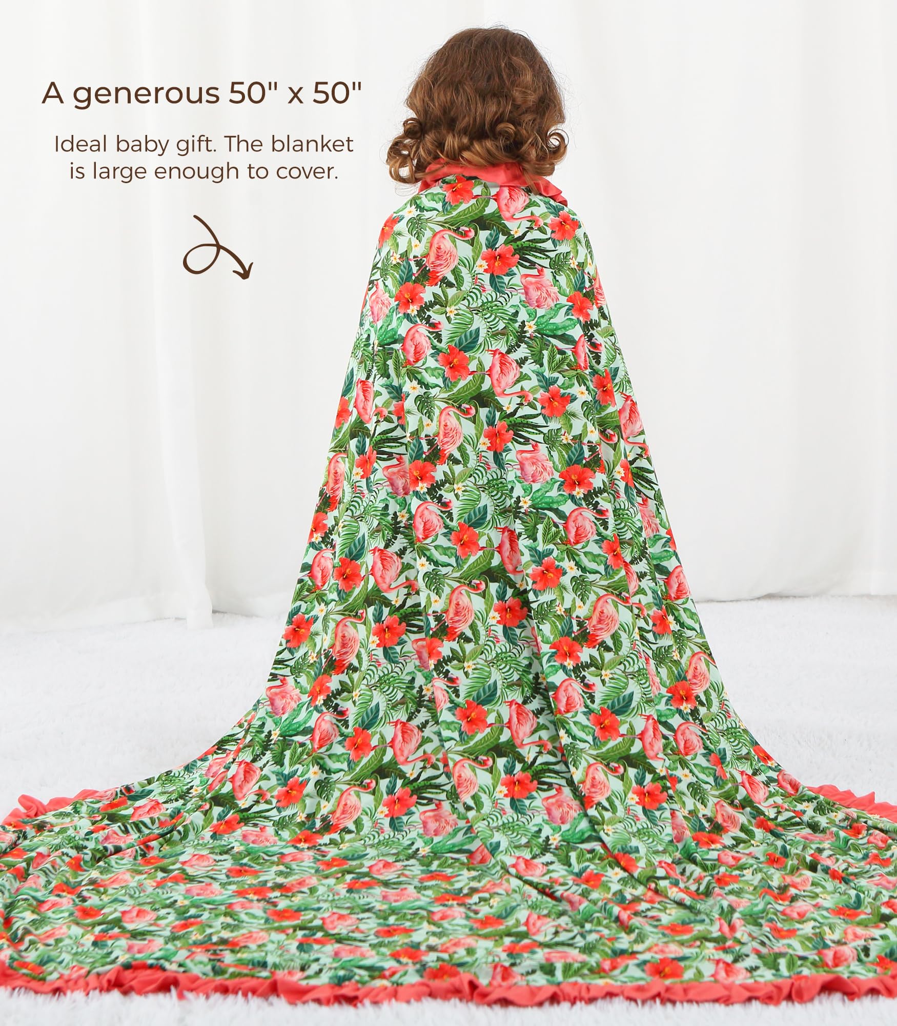 DREAMHALO Flamingo blanket spread on play mat shows swaddle and nursing wrap versatility