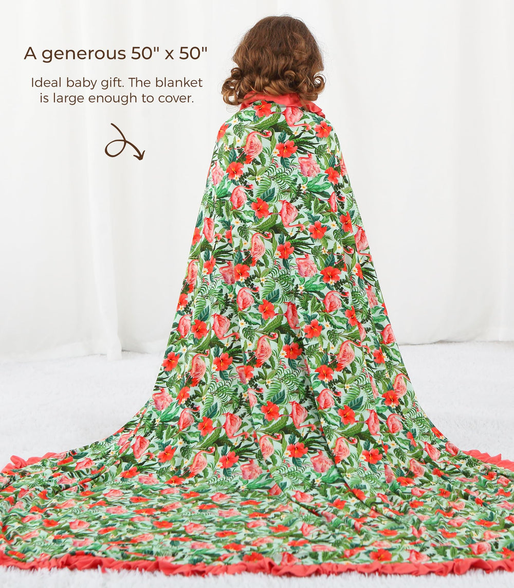DREAMHALO Flamingo blanket spread on play mat shows swaddle and nursing wrap versatility