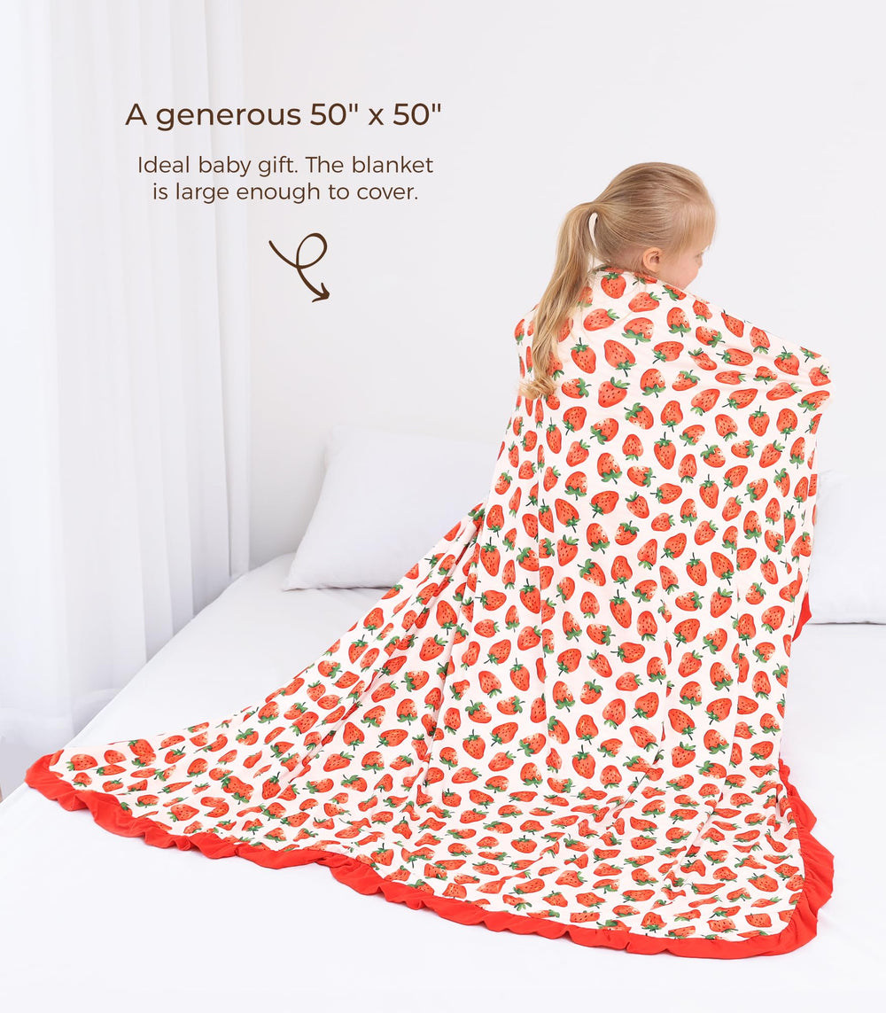 DREAMHALO Strawberry blanket toddler-use shot highlights cozy comfort during playtime or travel