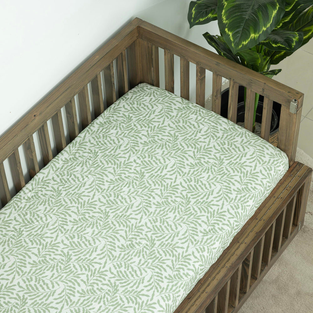 Dreamology Leaves muslin crib sheet toddler-fit for wrinkle-free bedtime transitions