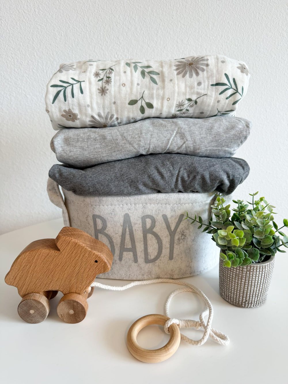 Dreamology muslin crib sheets packaged as a thoughtful baby shower gift.