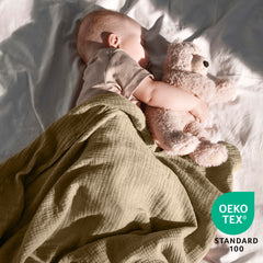 Dreamology muslin swaddle blanket packaged in a gift box for new parents.