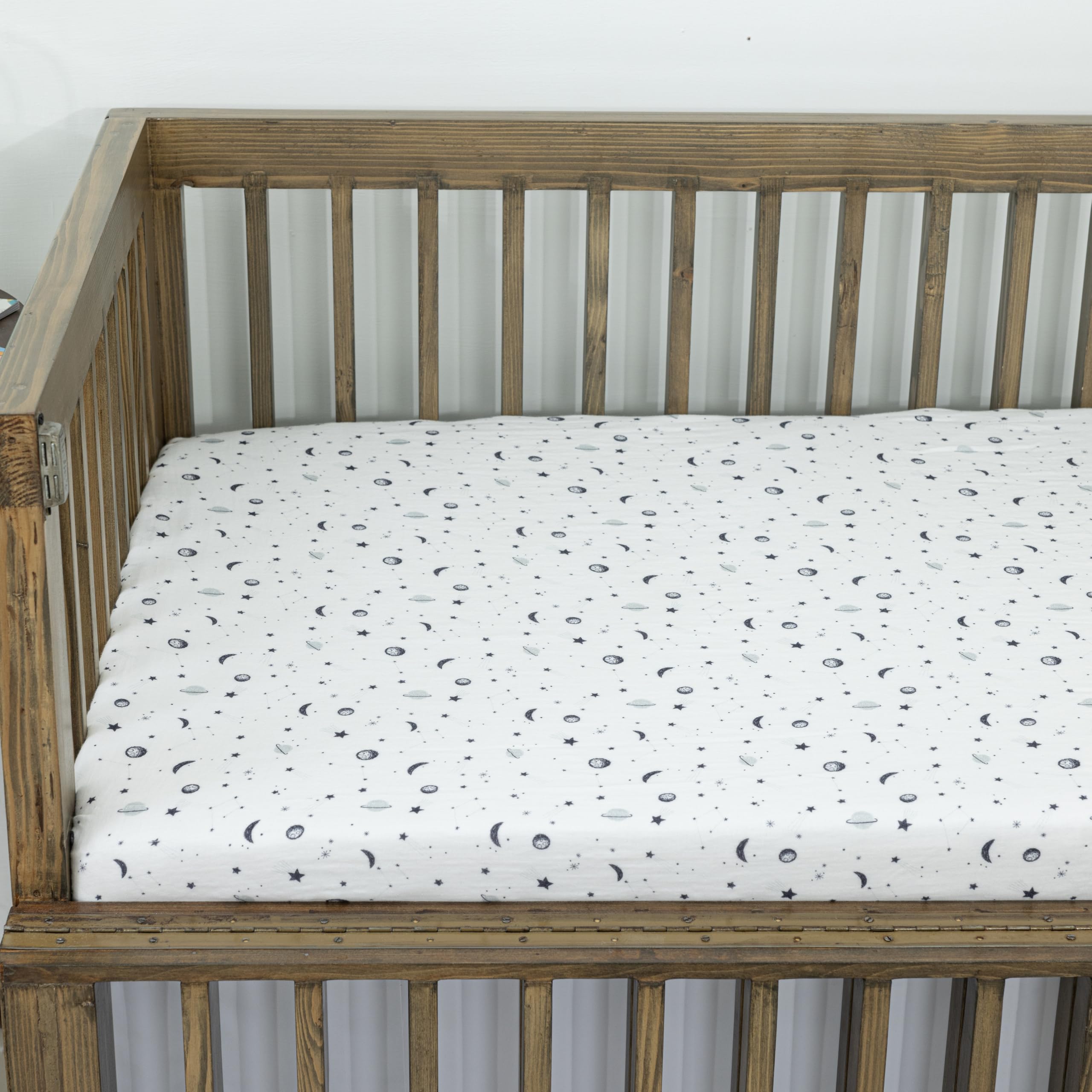 Dreamology Planets crib sheets being machine washed for easy care and quick cleanup.