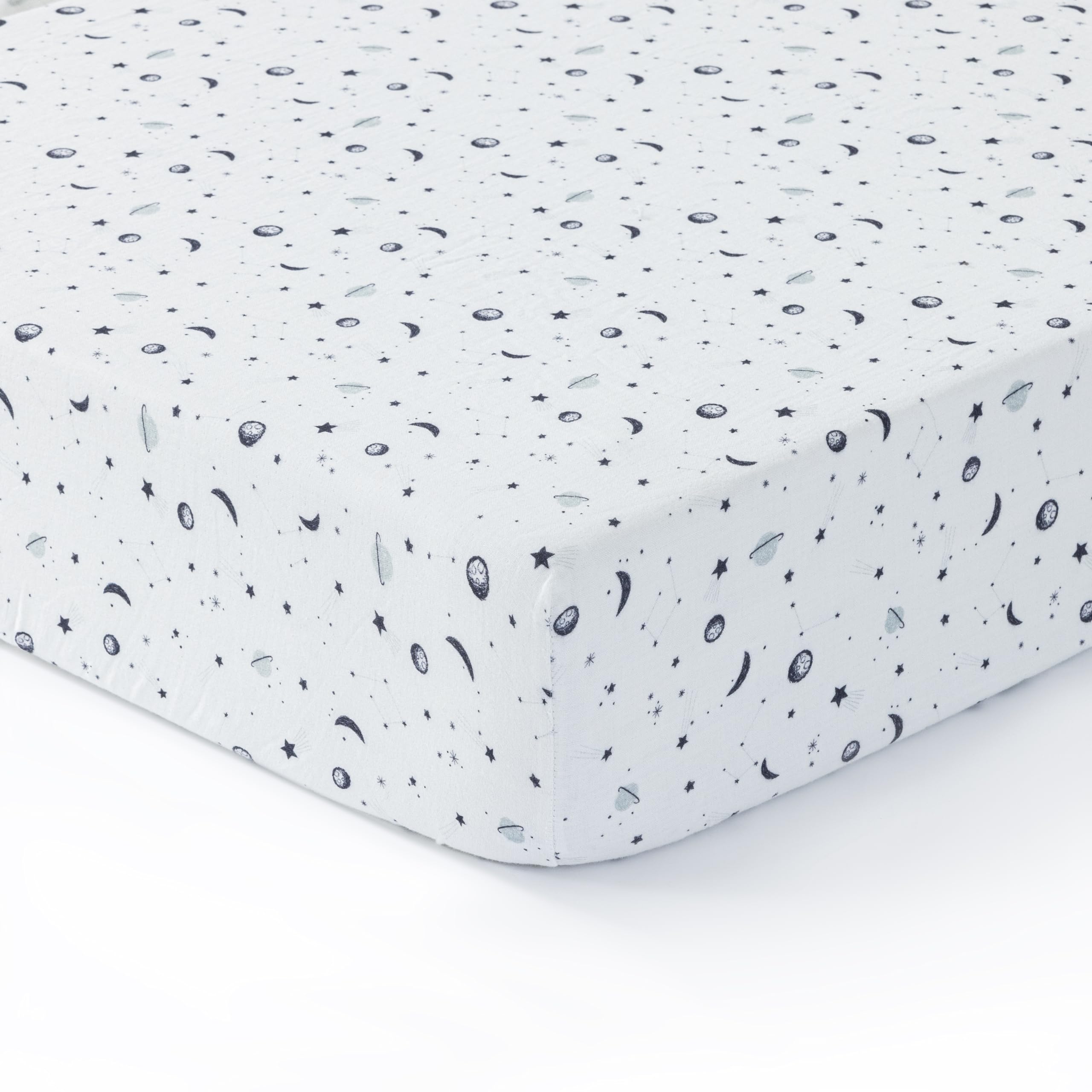 Dreamology Planets crib sheets close-up showing soft muslin fabric for gentle baby skin.