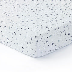 Dreamology Planets crib sheets close-up showing soft muslin fabric for gentle baby skin.